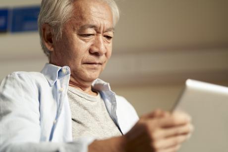 Older man looking at a tablet