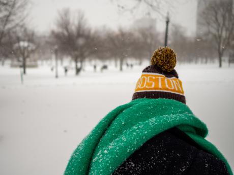 Person from behind wearing a Boston hat, Boston Common in Snow