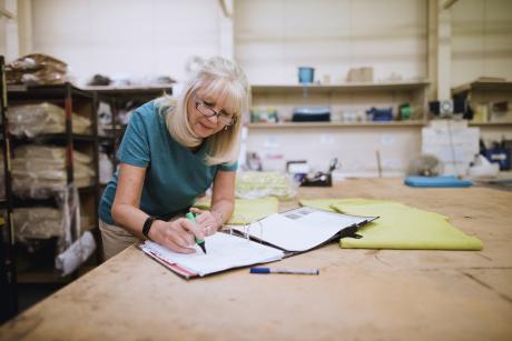 Older woman working in her design studio