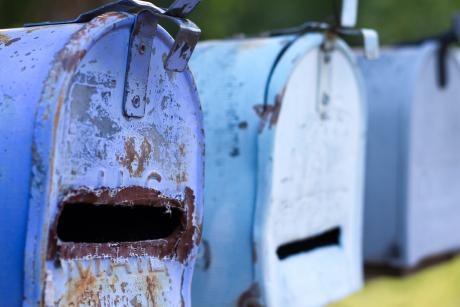 Line of Classic Rusty Blue Rural US Mailboxes