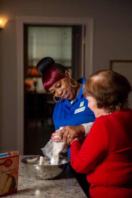 ursing assistant Michelle Godwin cares for a woman in a Florida memory care facility. Photo by Kristen Blush
