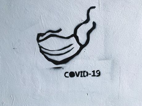 graffiti of a mask and text COVID-19