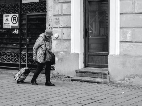 Older woman walking alone in city