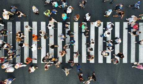 Ariel view looking down at a cross walk with lots of people crossing paths