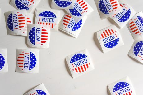 Red white and blue stickers that read "I voted"