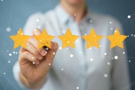 Businesswoman on blurred background rating with hand drawn stars stock photo