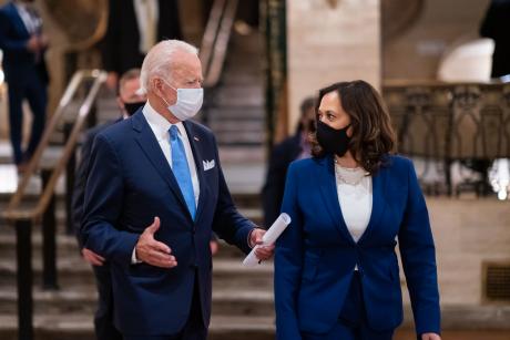 Joe Biden and Kamala Harris talking, both wearing masks