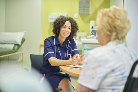 Provider talks with patient in a clinic