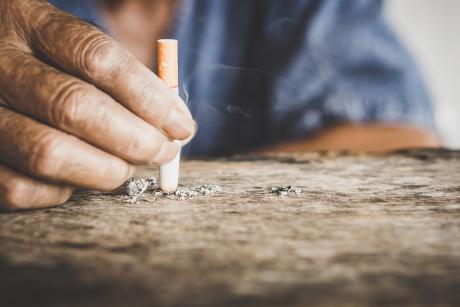 Closeup of man's hand putting out a cigarette