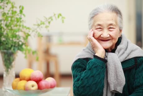 Older Asian woman smiling at camera