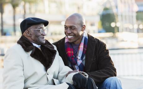 Black man and grandfather with blurred city background