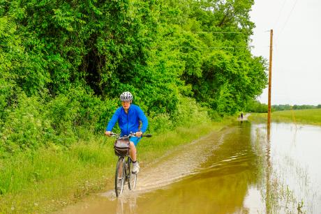 Man biking on flooded trail