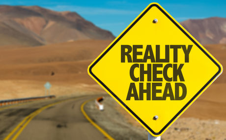 Road with sign Reality Check Ahead