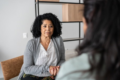 Older Latina listens to daughter or therapist