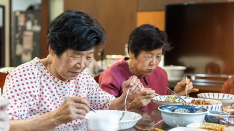 Older women enjoying a meal together, Asia