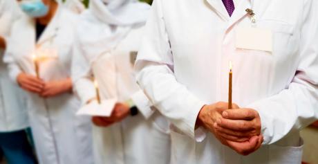Doctors line up with candles