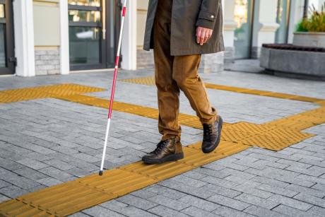 Blind man walking on navigation strips