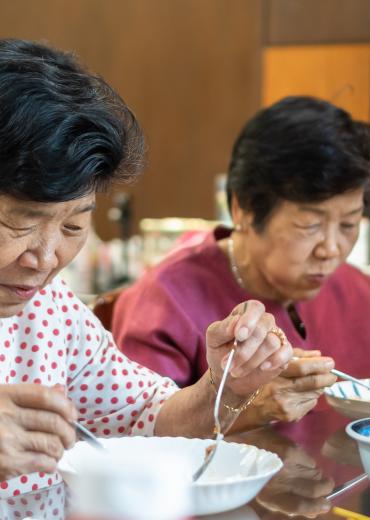 Older women enjoying a meal together, Asia