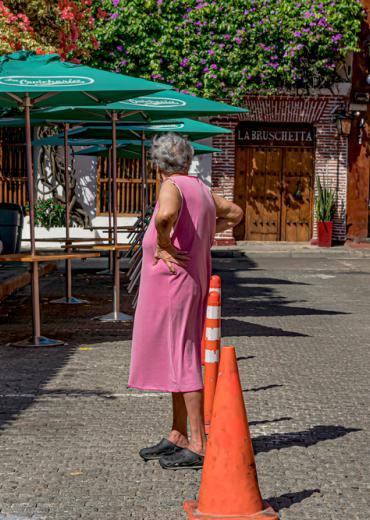 Woman in pink dress seeking cooler temps