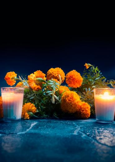 Candles burning with marigolds, death
