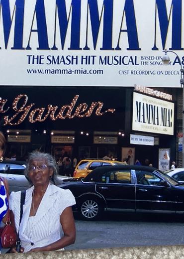 Julia Y and her mom in front of Mamma Mia! sign