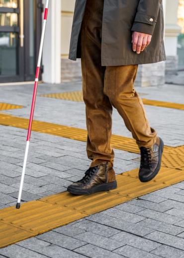 Blind man walking on navigation strips