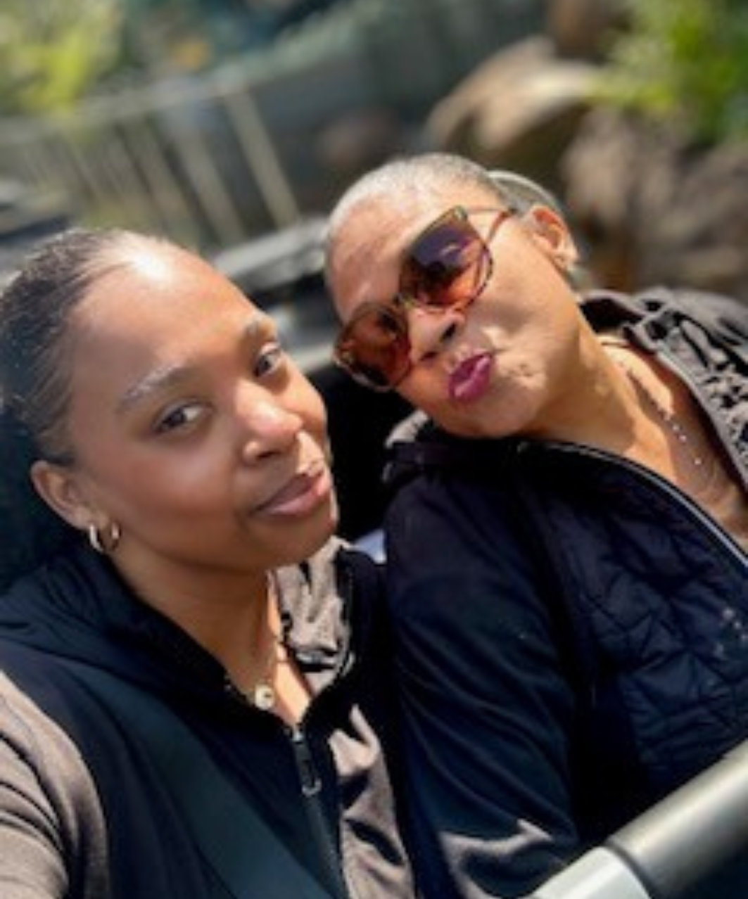 Vanessa Font and her mother take a closeup selfie outdoors, smiling at the camera.