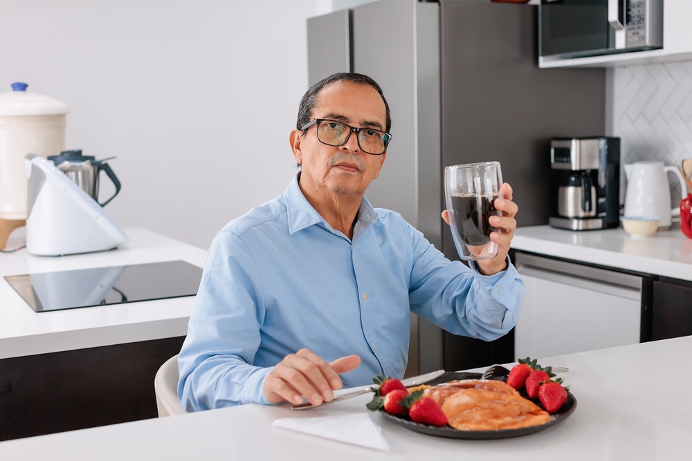 Man at dinner table with healthy meal