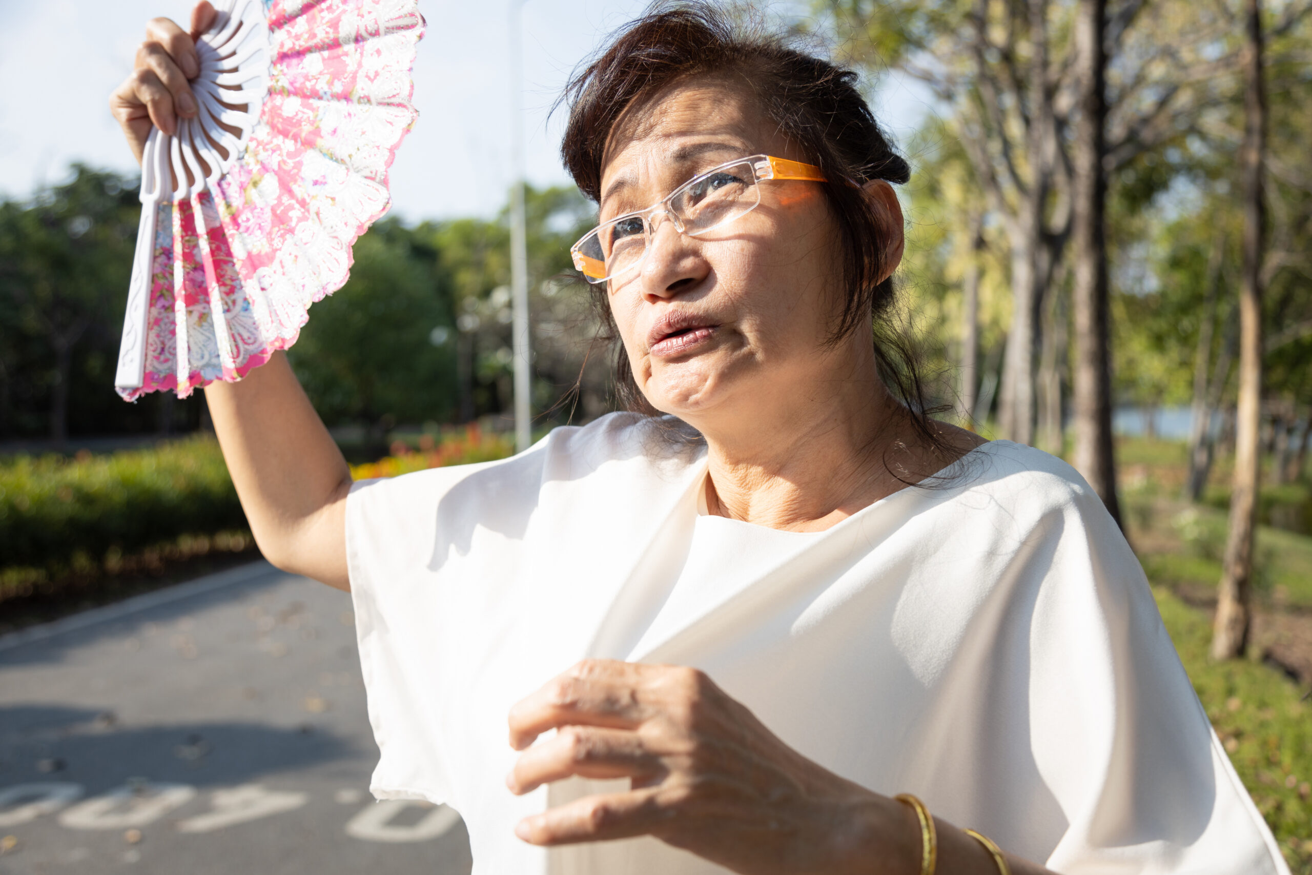 Asian,Senior,Woman,Fanning,And,Sweat,On,Face,Suffer,From